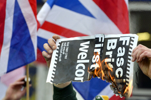 Burning a placard. Copyright Phil Robinson / PjrFoto.com